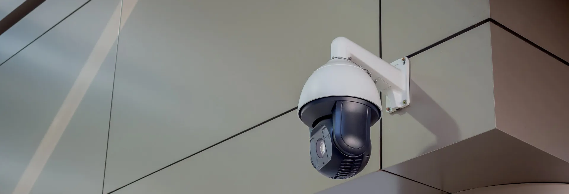 PTZ security camera mounted on a modern commercial building